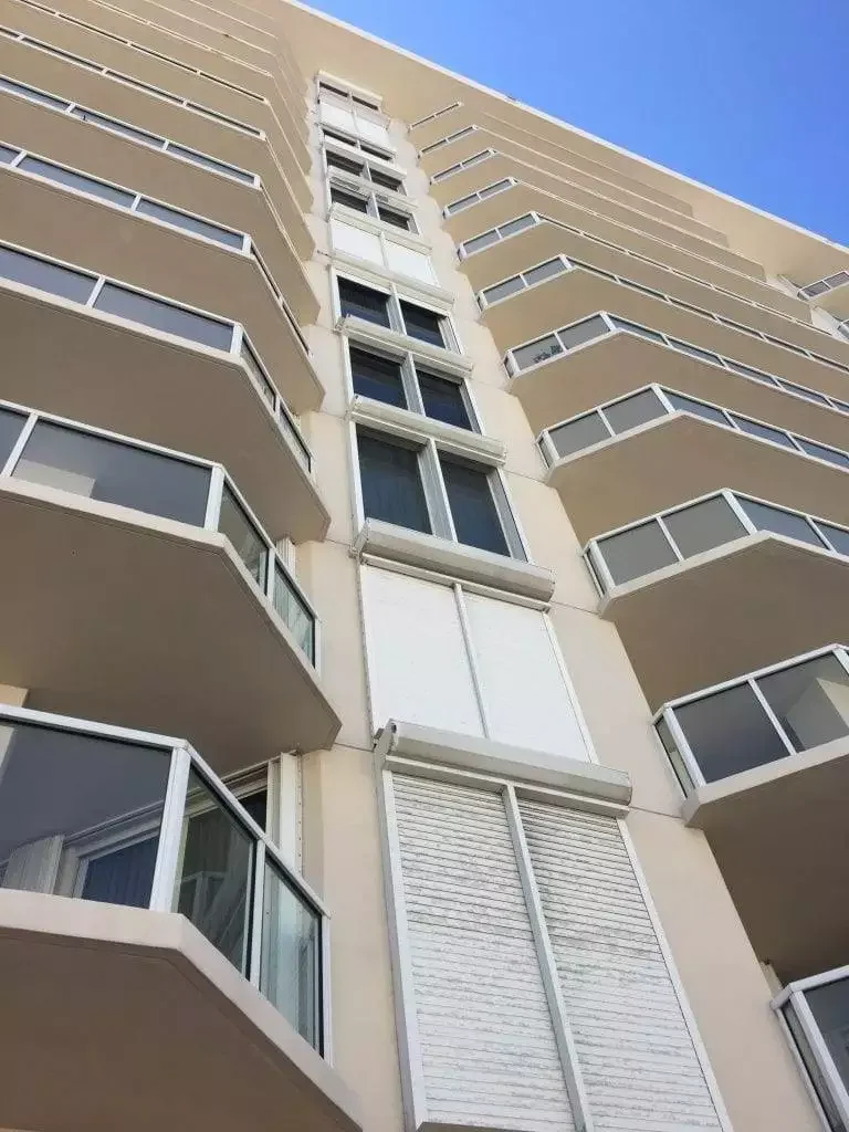 High-rise tall building with a shutter on upper floors