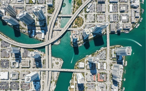 Aerial cityscape with high-rises, bridges, and waterways—ideal for showcasing urban infrastructure and coastal planning.