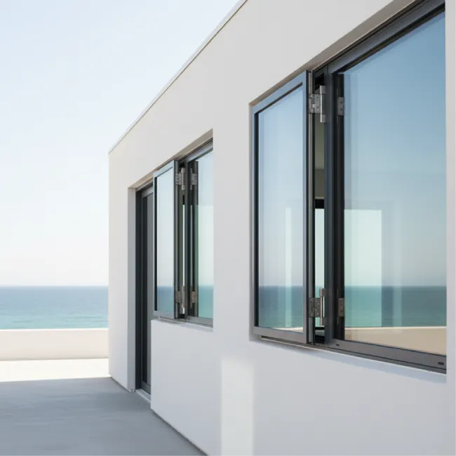 Modern white building with open glass windows and ocean view in background